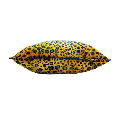 Side view of the Safari Spot Pillow showing the plush square shape, leopard print fabric, and dark piping along the edge.