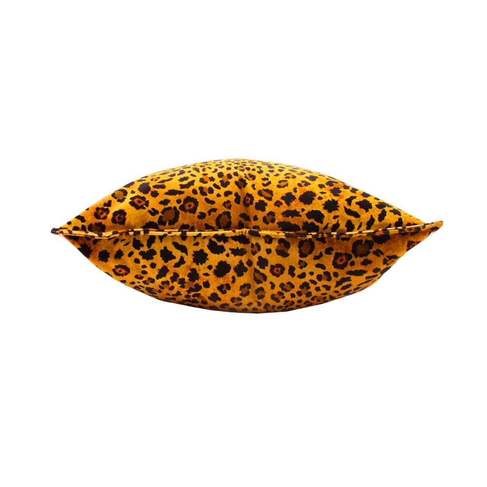 Side view of the plush Safari Spot Pillow laying flat, highlighting its velvet texture and piped seam detail.