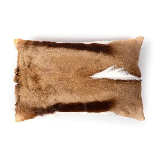 Rectangular springbok hide pillow featuring natural light brown fur with dark brown accent stripes and a white crest along the center.