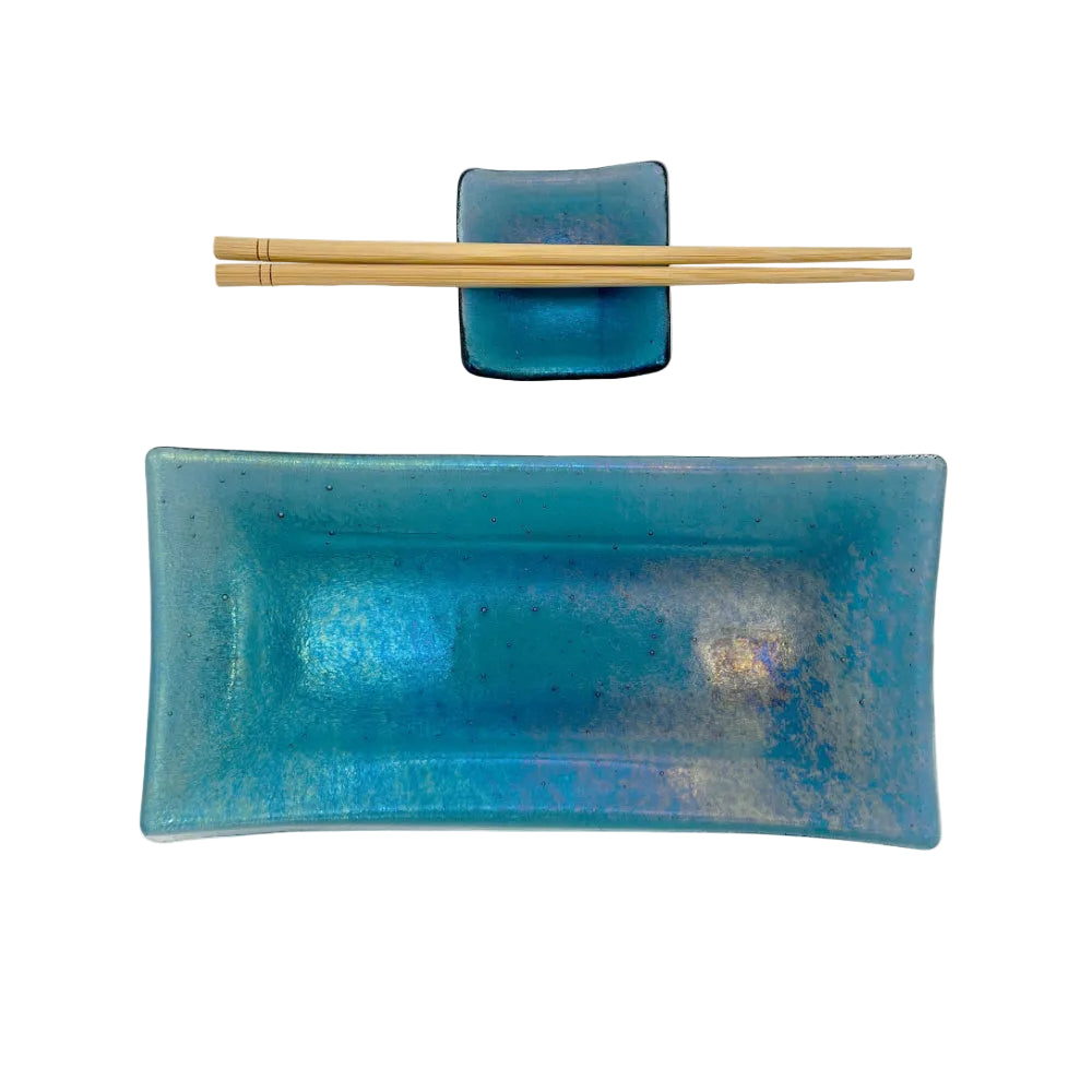 Handmade turquoise glass sushi set featuring a rectangular serving plate, matching square sauce dish, and a pair of light wood chopsticks on a white background.