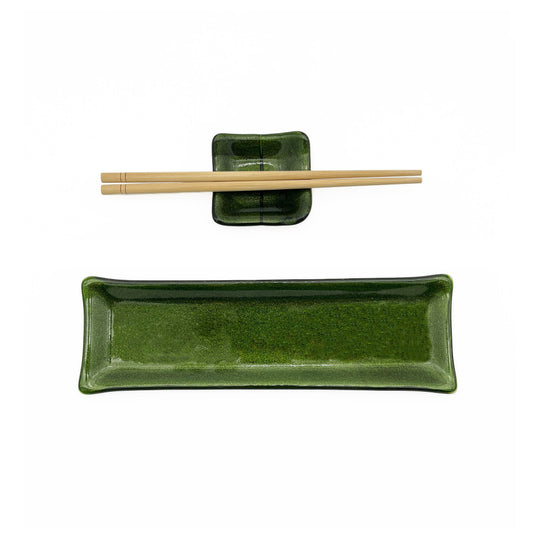 Handmade green glass sushi set featuring a rectangular serving plate, matching square sauce dish, and a pair of light wood chopsticks on a white background.