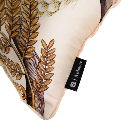 Close-up of Thanda Pangolin pillow showing botanical print, piped trim, and Ardmore label.