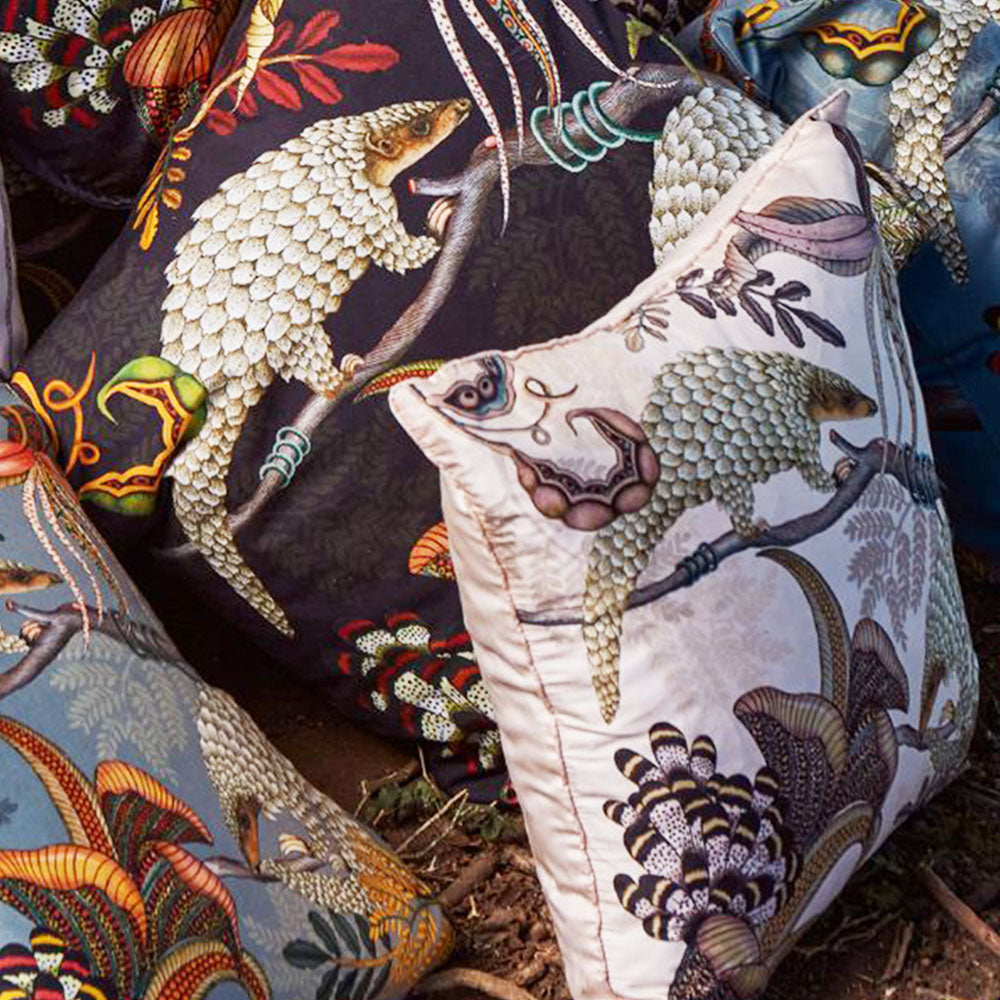 Thanda Pangolin pillow styled with coordinating Ardmore pillows featuring pangolin and botanical designs.