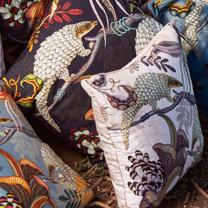 Thanda Pangolin pillow styled with coordinating Ardmore pillows featuring pangolin and botanical designs.