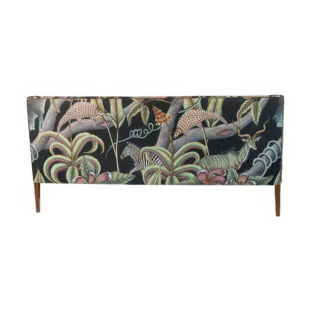 Back view of the Thanda Sofa fully upholstered in dark fabric featuring illustrated safari animals including a zebra, a kudu, chameleons, and lush botanical elements.