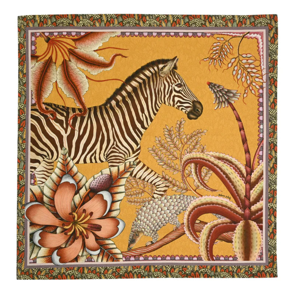 Thanda Stripe napkin in flame orange with zebra, pangolin, gardenias, aloes, and patterned border.