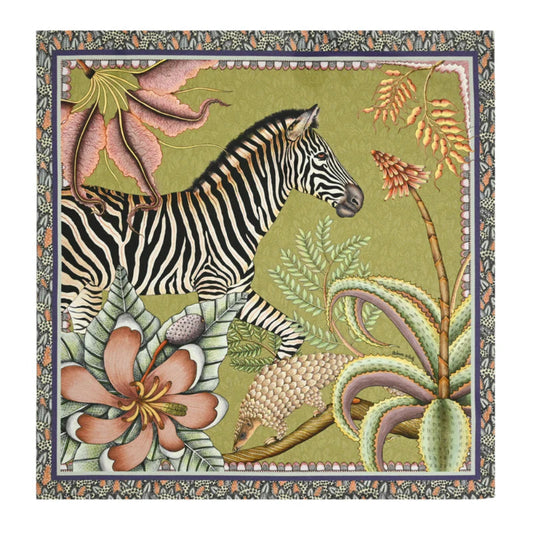 Thanda Stripe Napkin featuring an illustrated zebra surrounded by oversized flowers, tropical foliage, and botanical details in olive green, pink, cream, coral, and black with a decorative border.