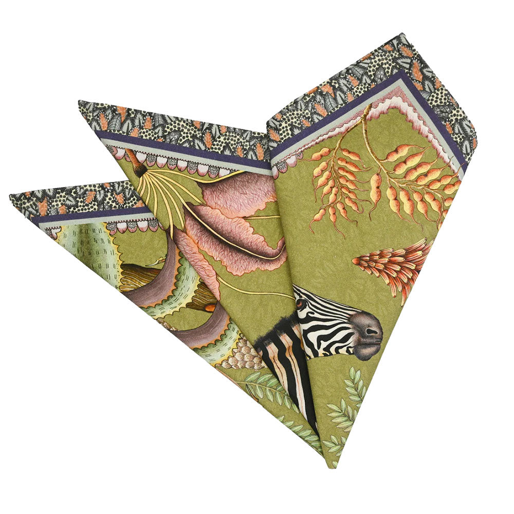 Thanda Stripe Napkin folded into a decorative fan shape, showing zebra artwork, tropical leaves, flowers, and botanical details in olive green, pink, cream, and coral tones.