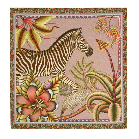 Thanda Stripe Napkin featuring an illustrated zebra surrounded by oversized flowers, tropical foliage, and botanical details in pink, coral, green, cream, and earthy tones with a decorative border.