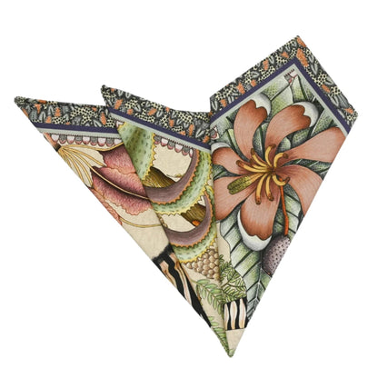 Thanda Stripe Napkin folded into a decorative fan shape, showing large floral details, tropical leaves, zebra stripes, and the patterned border in warm earthy tones.