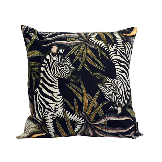 Thanda Stripe Pillow featuring two illustrated zebras surrounded by layered cream, olive, gold, and earthy botanical foliage on a deep navy background.