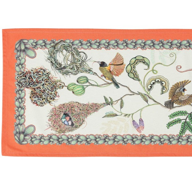 Close-up of the Ardmore table runner showing illustrated birds, woven nests with eggs, curling vines, and a patterned botanical border.