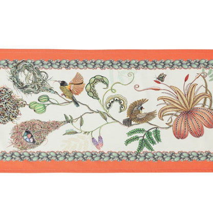 Close-up of the Ardmore table runner featuring two birds, a butterfly, seedpods, curling vines, and a large striped flower.