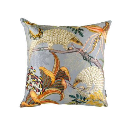 Square decorative pillow featuring two illustrated pangolins among colorful tropical flowers, branches, and foliage on a soft gray background.